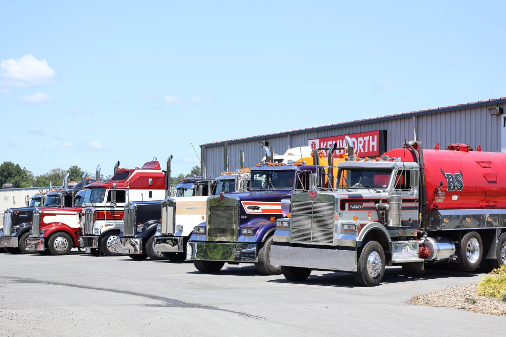 Different models of Kenworth trucks lined up outside the Kenworth of Pennsylvania Muncy facility.