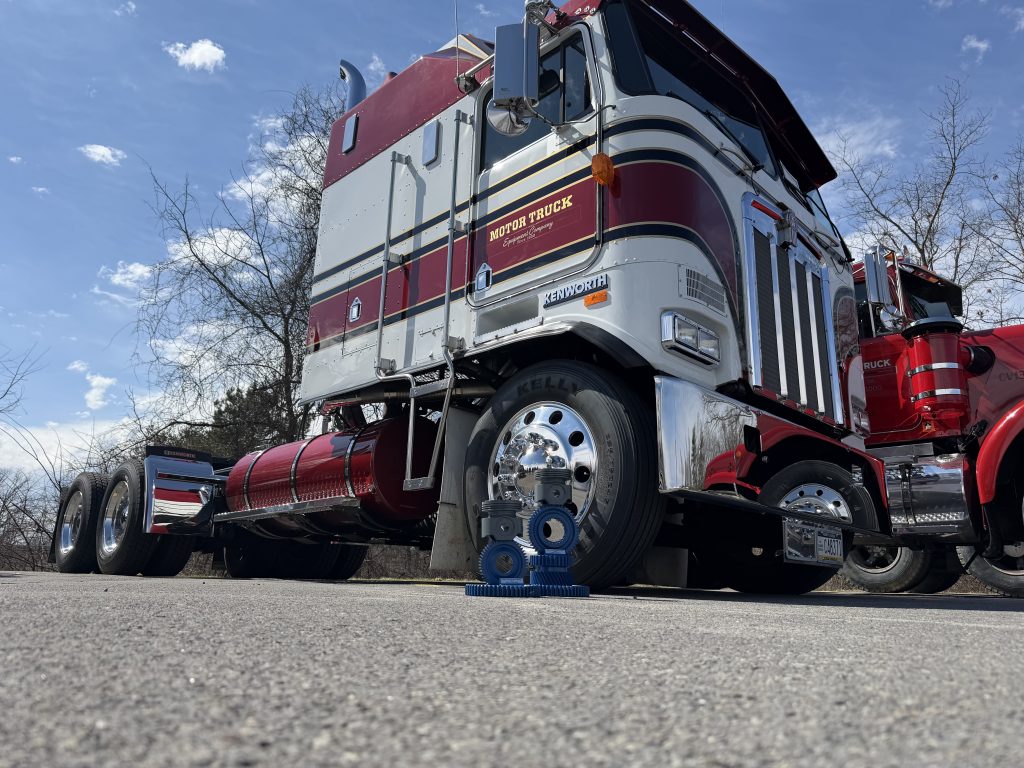 Kenworth K100E Cabover With Awards In Front Of It